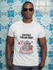 A white short-sleeved t-shirt with a cartoon graphic of a pigeon in a flamingo floatie drinking boba