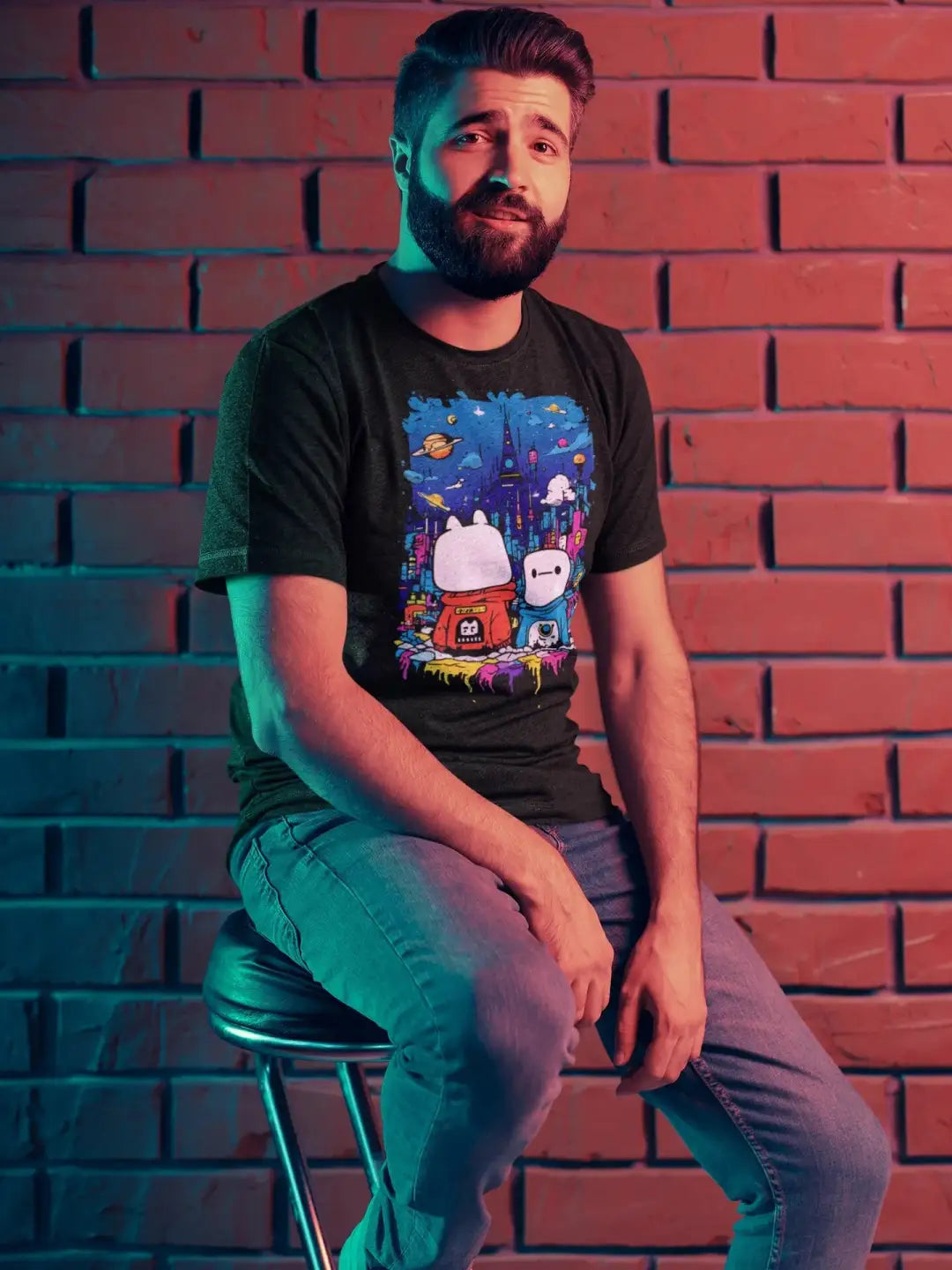 A man with a beard wearing a black graphic t-shirt and jeans.