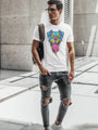 A man wearing a white t-shirt with a colorful dog graphic and ripped dark jeans