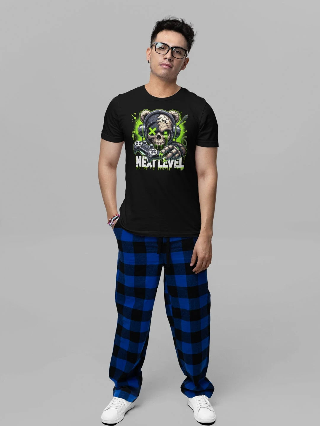 Black short-sleeved t-shirt featuring a vibrant graphic of a skull wearing headphones and holding a gaming controller, with the text ’next level’ printed below