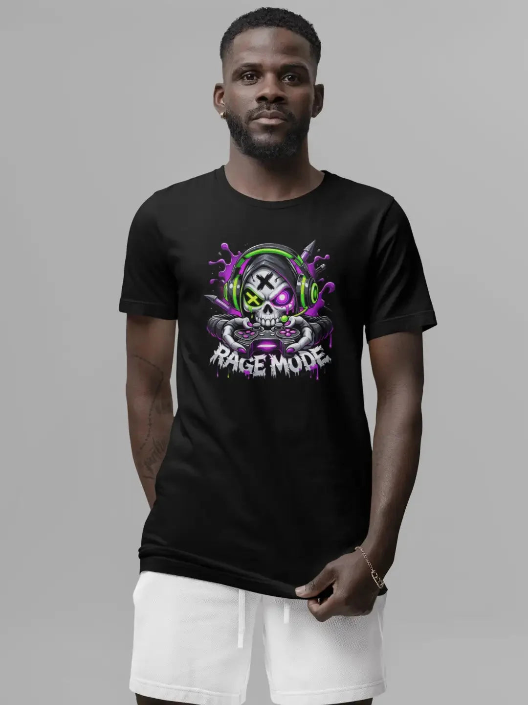 Black short-sleeved t-shirt featuring a vibrant graphic of a skull wearing green headphones and holding a controller, with the text ’rage mode’ below in stylized white lettering