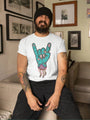 A bearded man wearing a black beanie and a white t-shirt with a cartoon zombie hand making the 