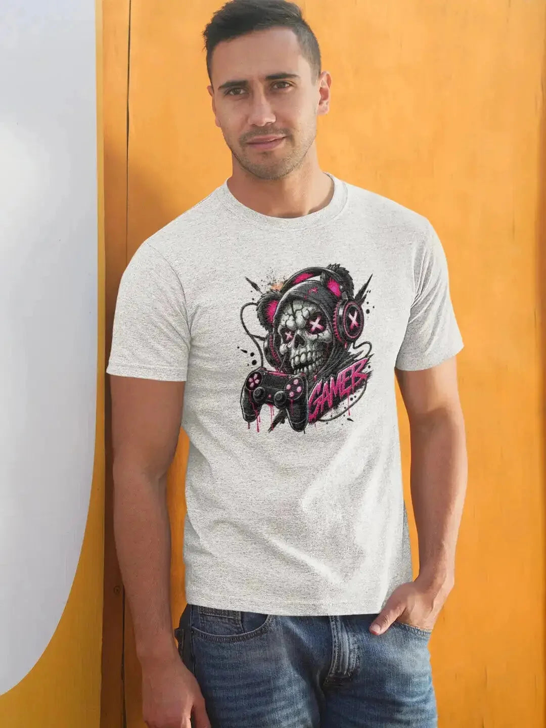 Heather gray short-sleeved t-shirt featuring a vibrant graphic of a skull wearing headphones and holding a game controller with the word ’games’ in stylized pink lettering