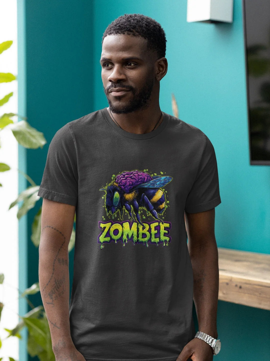 Dark gray cotton t-shirt featuring a vibrant zombie bee graphic with purple brain and green dripping text